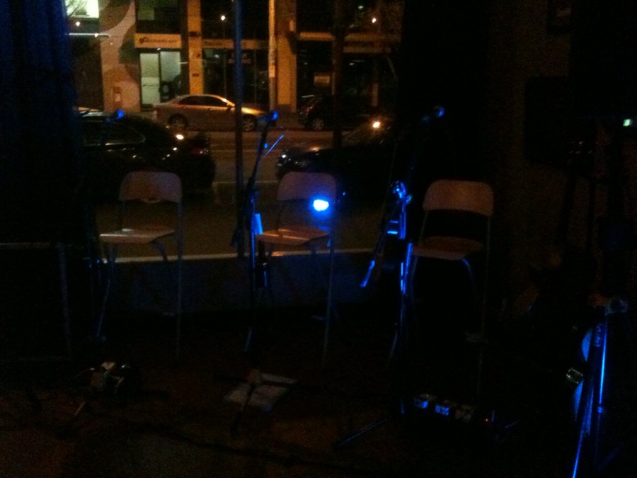 Stools under blue stage light at night