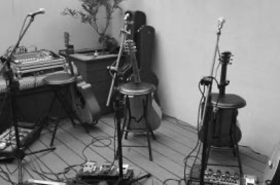 Stools, guitars and mic stands in a quiet room